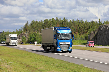 Image showing DAF Semi Trucks Transport Merchandise among Traffic