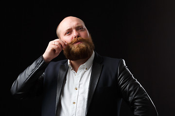 Image showing Man twirling his ginger mustaches