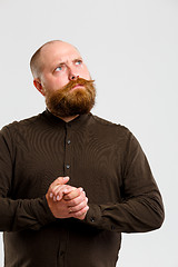 Image showing Pensive man in brown shirt