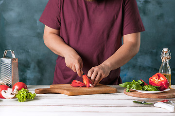 Image showing Closeup hand of chef baker making pizza at kitchen