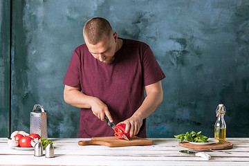 Image showing Closeup hand of chef baker making pizza at kitchen