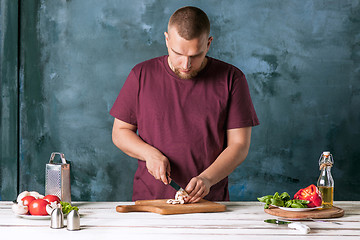 Image showing Closeup hand of chef baker making pizza at kitchen