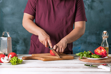 Image showing Closeup hand of chef baker making pizza at kitchen