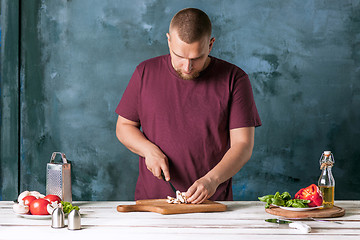 Image showing Closeup hand of chef baker making pizza at kitchen