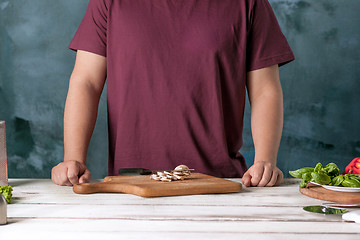 Image showing Closeup hand of chef baker making pizza at kitchen