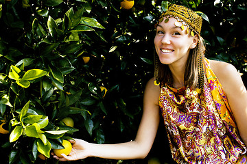 Image showing pretty islam woman in orange grove smiling, real muslim girl che