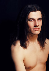 Image showing handsome young man with long hair naked torso on black backgroun