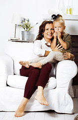 Image showing happy smiling mother with little cute daughter at home interior,