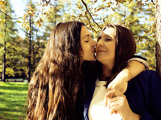 Image showing mature real mother with daughter outside autumn fall in park