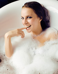 Image showing young cute sweet brunette woman taking bath, happy smiling people concept