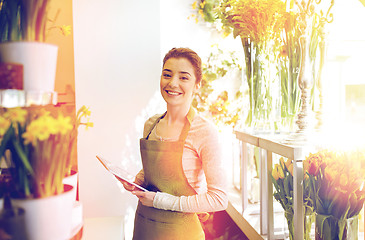 Image showing woman with tablet pc computer at flower shop