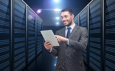 Image showing businessman with tablet pc over server room