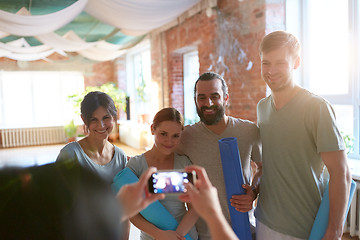 Image showing happy people at yoga studio or gym photographing