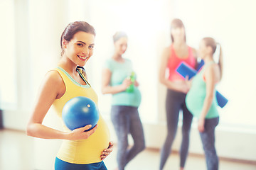 Image showing happy pregnant woman with ball in gym