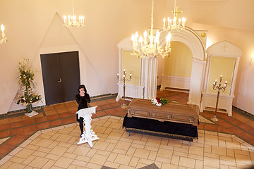 Image showing crying woman near coffin at funeral in church