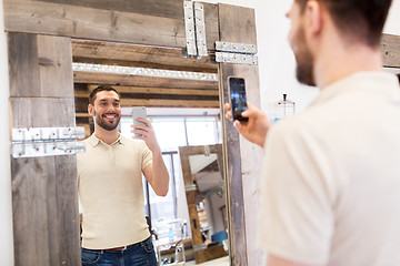 Image showing man taking selfie by smartphone at barbershop