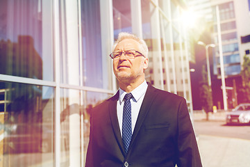 Image showing senior businessman on city street