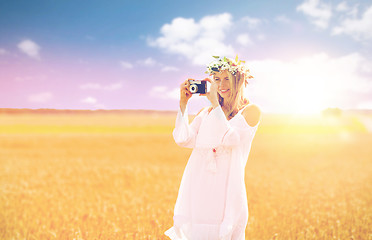 Image showing happy woman with film camera in wreath of flowers