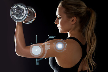 Image showing young sporty woman exercising with dumbbell