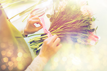 Image showing close up of woman making bunch at flower shop