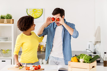 Image showing happy couple cooking food and having fun at home