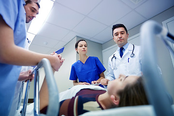 Image showing medics and patient on hospital gurney at emergency