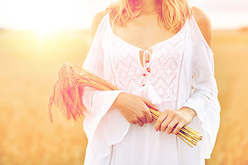 Image showing close up of happy woman with cereal spikelets