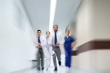 Image showing group of medics walking along hospital