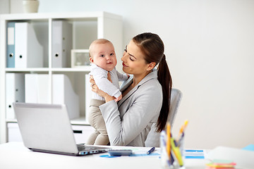 Image showing happy businesswoman with baby and laptop at office