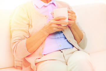 Image showing close up of senior woman with tea  cup at home