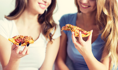 Image showing happy friends or teen girls eating pizza at home