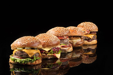 Image showing Burgers On Black Glass