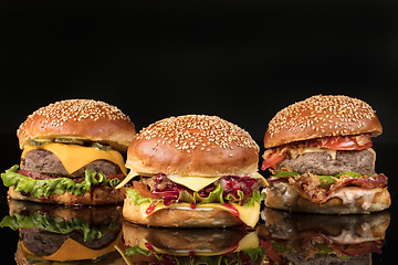 Image showing Burgers On Black Glass
