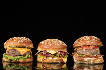 Image showing Burgers On Black Glass