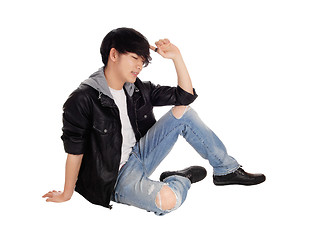 Image showing Young Asian man sitting on floor.