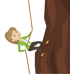 Image showing Business woman climbing on the mountain.