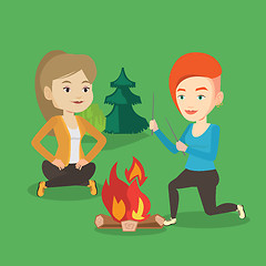 Image showing Two friends sitting around bonfire in camping.