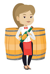 Image showing Waitress holding bottle of alcohol.