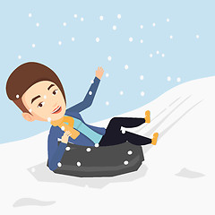 Image showing Woman sledding on snow rubber tube in mountains.