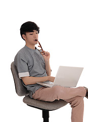 Image showing Young man working at laptop.