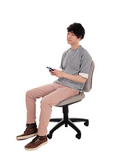 Image showing Asian man listening on his cell phone.