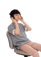 Image showing Asian man listen head phone.