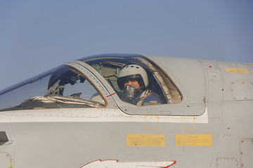 Image showing Military pilot in the cockpit of a jet aircraft