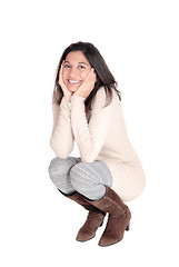 Image showing Happy woman crouching on floor.