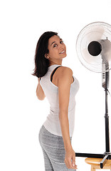 Image showing Woman cooling up on fan.