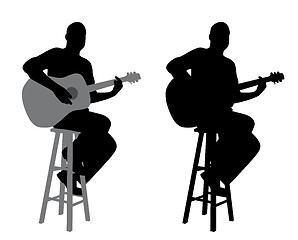 Image showing Guitar player sitting on a bar stool