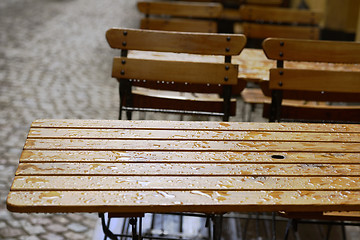Image showing empty coffee tables in the rain