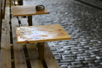 Image showing empty coffee tables in the rain