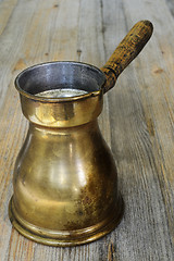 Image showing old arabic coffee pot on wooden background