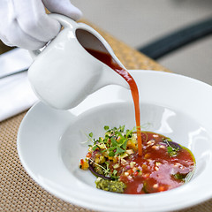 Image showing Waiter serving gazpacho, tomato soup 